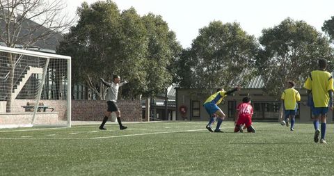 Soccer Players Strategizing During Practice on Field