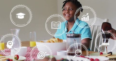 Joyful breakfast of young boy surrounded by digital learning icons