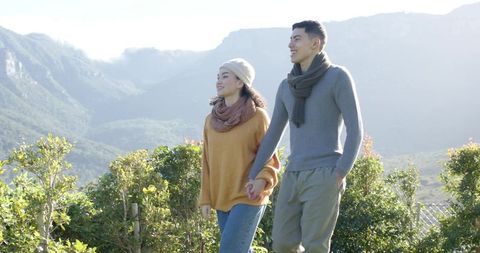 Couple Enjoying Scenic Mountain Walk Holding Hands