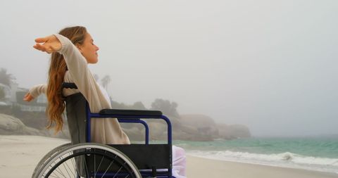 Blissful Woman in Wheelchair Relaxing at Serene Beachfront