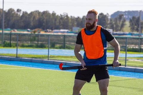Male field hockey player training on synthetic turf