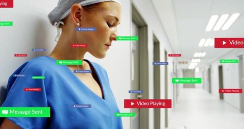 Nurse in hospital corridor with floating digital notifications