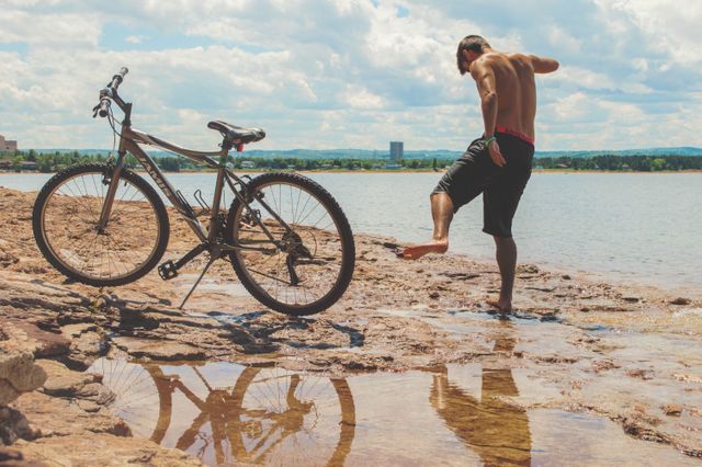Man Enjoying Summer Day by Lake with Bicycle - Download Free Stock Photos Pikwizard.com