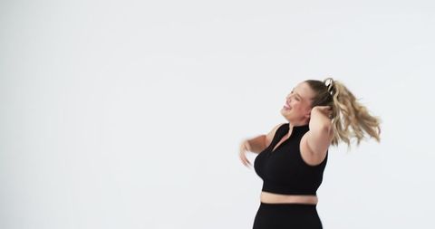 Joyful plus size woman dancing celebrating body positivity