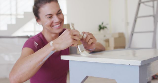 Woman Smiling While Painting Wooden Furniture in House - Download Free Stock Images Pikwizard.com