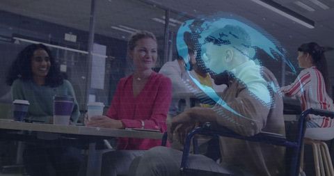 Inclusive office team collaborating over coffee with wheelchair and holographic ar globe