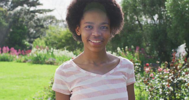 Smiling Young Adult Standing in Garden on Sunny Day - Download Free Stock Images Pikwizard.com