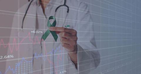 Medical Professional Holding Green Ribbon Analyzing Healthcare Data
