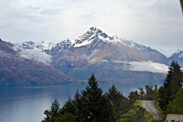 Snow-Capped Mountain by Serene Lake under Cloudy Sky - Download Free Stock Photos Pikwizard.com
