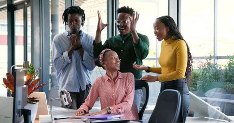 Team Celebrating Successful Project Milestone in Modern Office