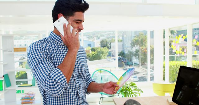 Businessman Talking on Phone While Holding Color Swatch - Download Free Stock Images Pikwizard.com