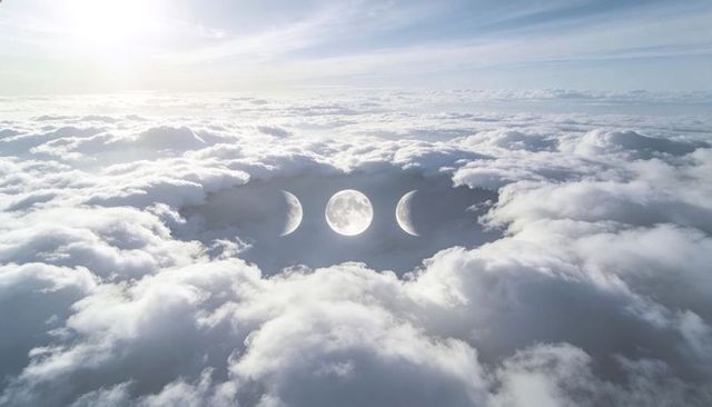 Surreal triple moons hovering above endless cloud sea at sunrise, celestial dreamscape