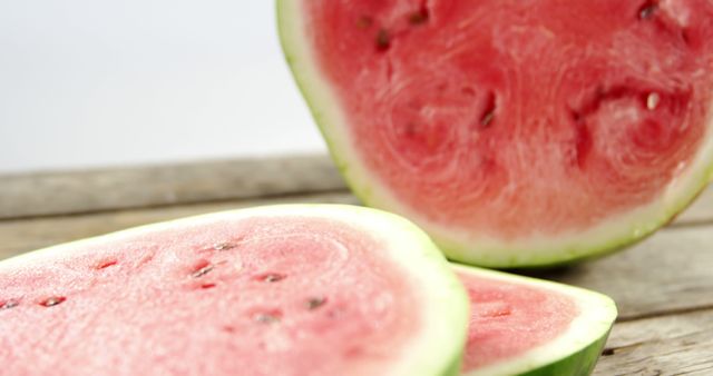 Slices of juicy watermelon are placed on a rustic wooden surface, with copy space. Watermelon is a refreshing fruit often associated with summer and healthy eating.