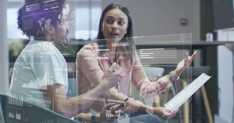 Two Professionals Collaborating and Analyzing Augmented Reality Data Dashboards in Office