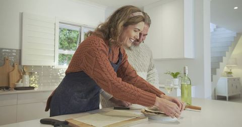 Couple Preparing Pastry Together in Modern Home Kitchen