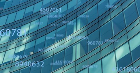 Digital Data Flowing Over Modern Office Building Facade