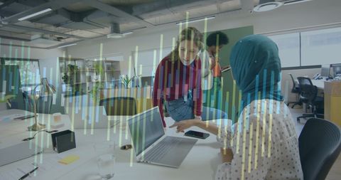 Diverse Team Discussing Data with Financial Graph Overlay in Office