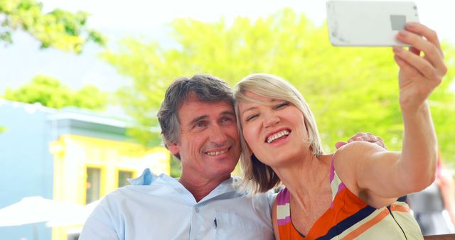 Smiling couple taking selfie in the city