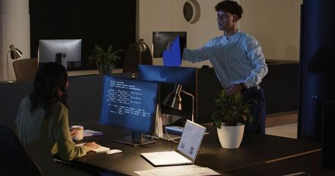Diverse Team Collaborating Late in Office