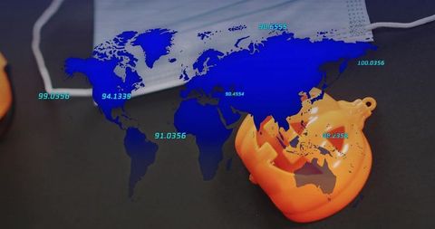 Global health data map overlaying surgical mask and halloween pumpkin ornament