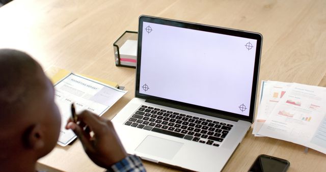 Businessman Analyzing Financial Reports on Laptop at Desk - Download Free Stock Images Pikwizard.com