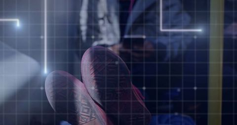 Futuristic grid overlaid on smartphone user's sneakers