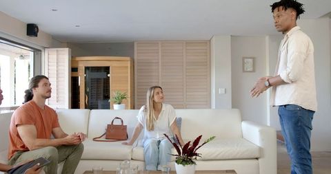 Animated Discussion Among Friends in Modern Living Room