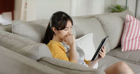 Young woman relaxed at home with tablet