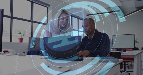 Team collaborating over laptop with augmented reality overlay in modern open office studio