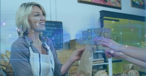 Smiling baker handing brown bag while customer tapping contactless payment, digital overlay showing 