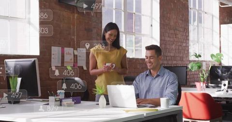 Coworkers collaborating in modern open plan office space
