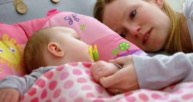 Mother Gazing at Baby While Holding Hand in Bed - Download Free Stock Images Pikwizard.com