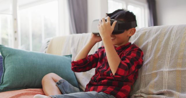 Young Boy Enjoying Virtual Reality Experience on Couch - Download Free Stock Images Pikwizard.com
