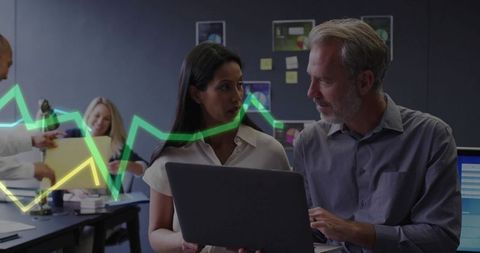 Business Colleagues Discussing Data on Laptop at Office Workspace