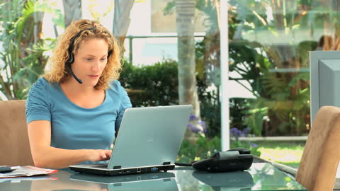 Businesswoman Using Headset for Remote Communication