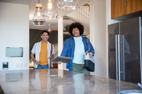 Modern Male Friends Enter Kitchen with Technology