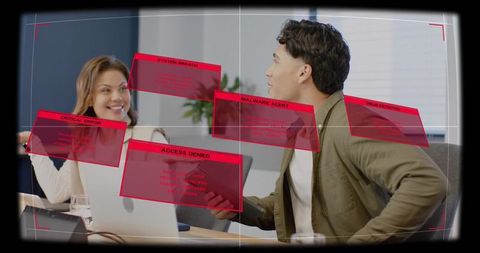 Colleagues reacting to cybersecurity breach alerts while collaborating in modern office