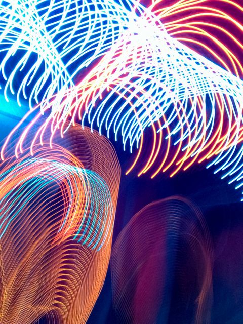 This abstract light trails image features a vibrant mix of colors in dynamic patterns, creating a sense of energy and motion. It can be used for various creative applications such as backgrounds, art projects, digital designs, and advertisements that require a lively and dynamic theme.