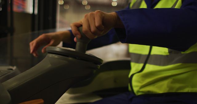 Operator Controlling Machinery with Handheld Lever, Safety Vest Focus - Download Free Stock Images Pikwizard.com