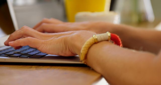 Close-up of Woman Typing on Laptop with Bracelet on Wrist - Download Free Stock Images Pikwizard.com