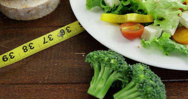 Healthy Salad with Fresh Vegetables and Measuring Tape for Diet Concept - Download Free Stock Images Pikwizard.com