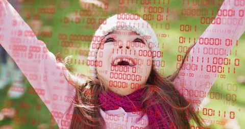Laughing girl raising arms outdoors, red binary overlay, playful digital childhood concept
