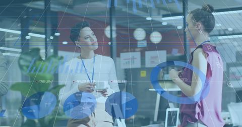 Diverse Business Team Analyzing Financial Data Graphics in Modern Office