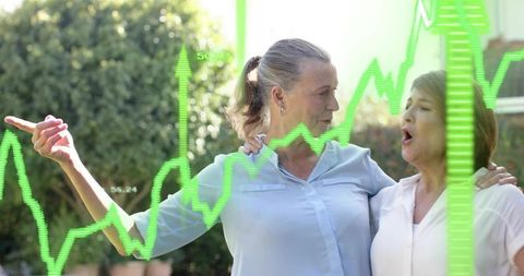 Mature Women Celebrating Investment Success with Neon Stock Market Graph Overlay