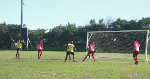 Intense Soccer Match with Players Aiming for Goal on Field