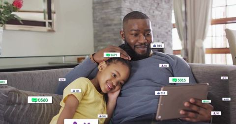 Father and Daughter Enjoying Tablet with Social Media Overlays