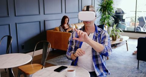 Businessman using virtual reality headset in modern office lobby