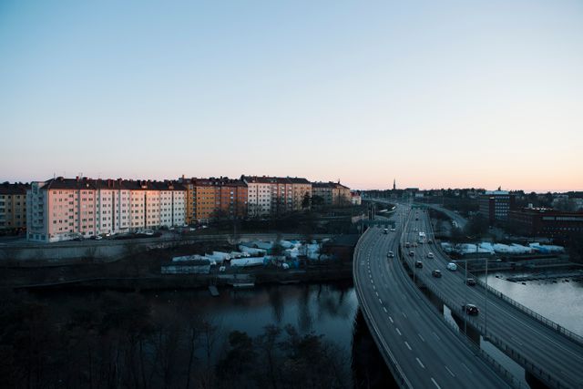 Aerial View of Urban Highway and Residential Buildings at Dusk - Download Free Stock Images Pikwizard.com