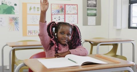 Confident Young Girl Answering in Classroom