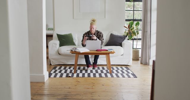 Albino Man with Dreadlocks Working Remotely from Cozy Living Room - Download Free Stock Images Pikwizard.com